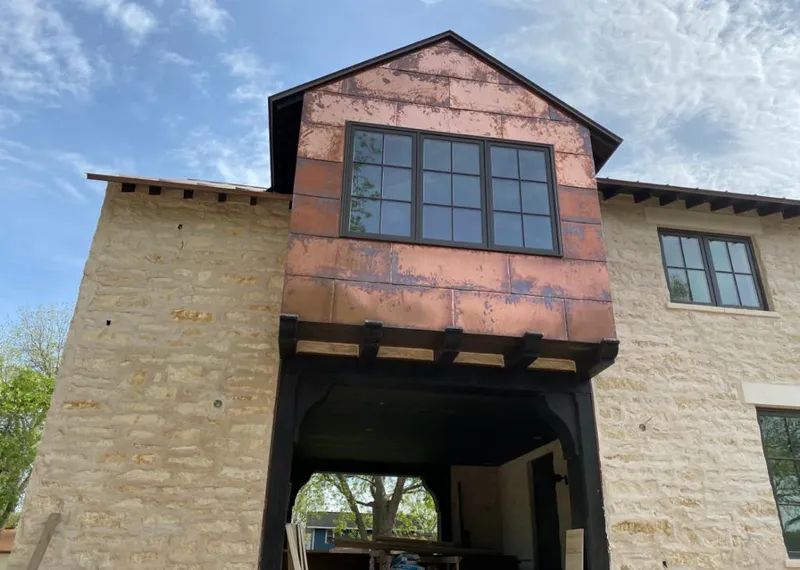 Copper metal panel facade on a stone building for Roof Repair in Zephyrhills South