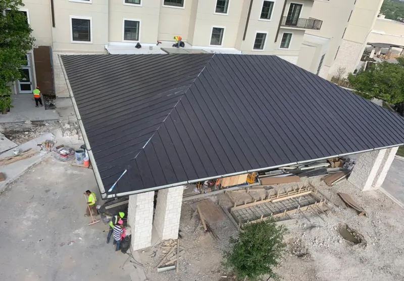 Metal roofing installation team working on a commercial building in Zephyrhills South